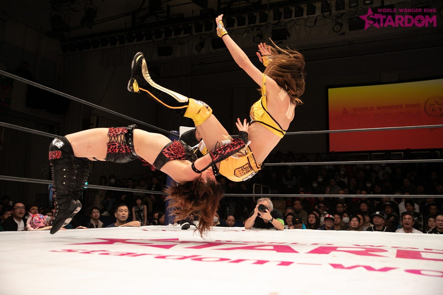 Utami Hayashishita hitting a German suplex on Arisa Hoshiki