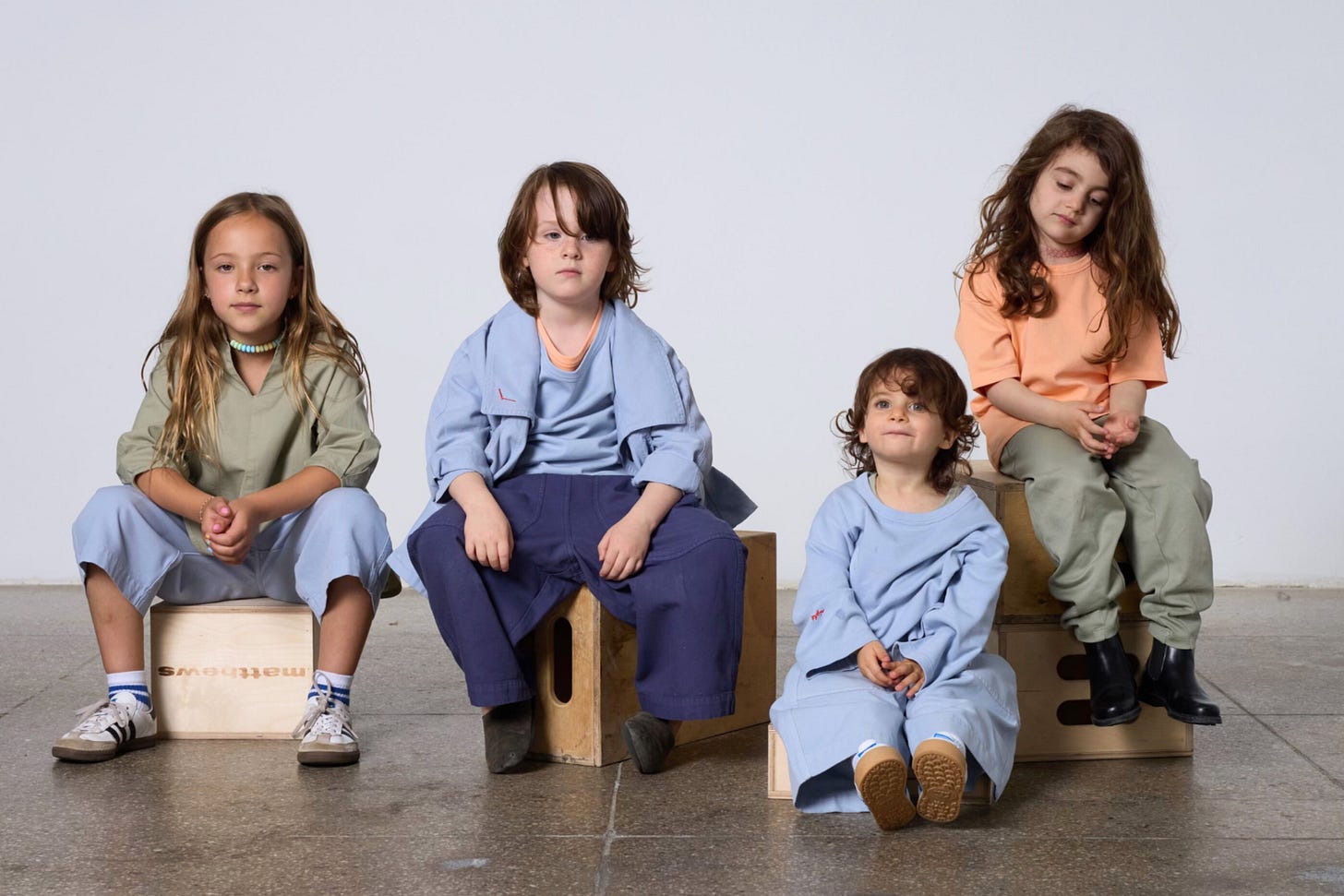 Kids wearing TwoThirtyTwo clothing sitting looking at the camera