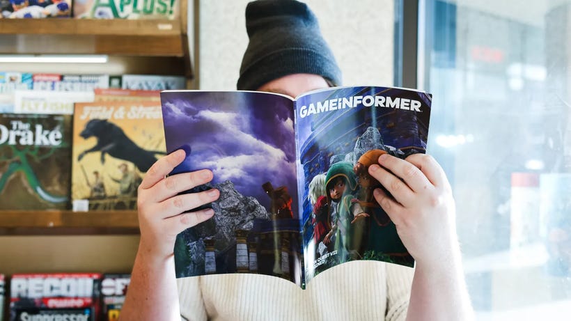 A person reads an issue of the new Game Informer. A person reads an issue of the new Game Informer.