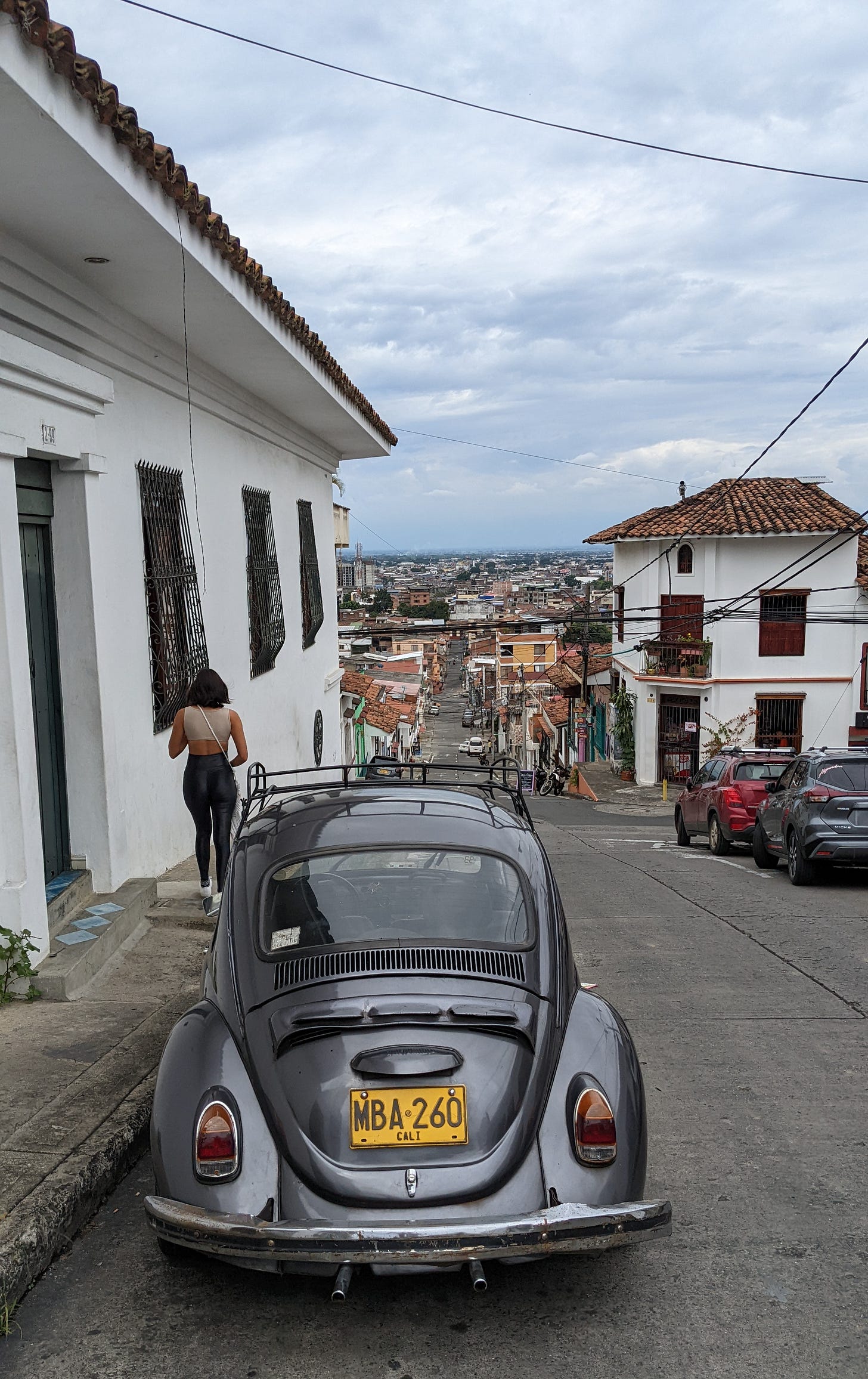 volkswagen bug with a cali license plate parked in barrio san antonio in cali, colombia