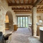 Blick ins großzügige Wohnzimmer mit Steinboden und Körben