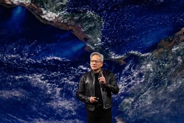 Jensen Huang, in a black jacket and clothes, speaks in front of a satellite image of Central America.