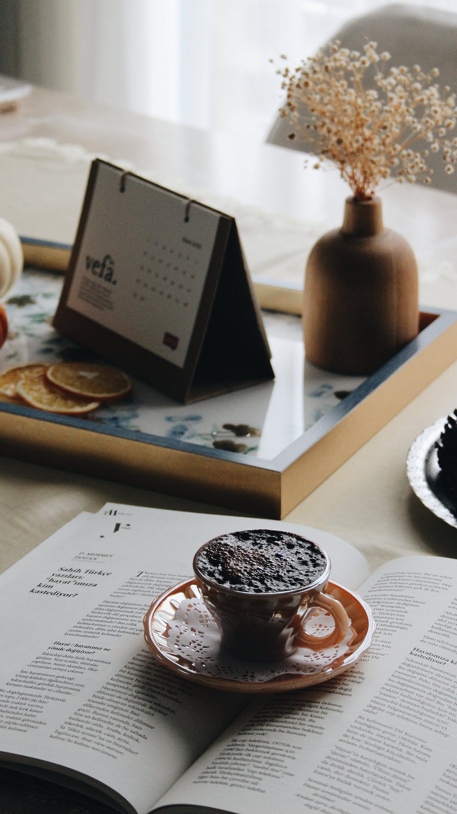 Coffee and a book and calender, set up ready to set goals