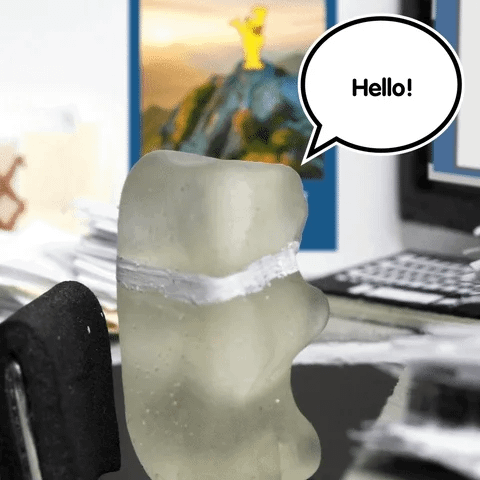 A gummy bear wearing a tie turns and says hello. A gummy bear wearing a tie turns and says hello.