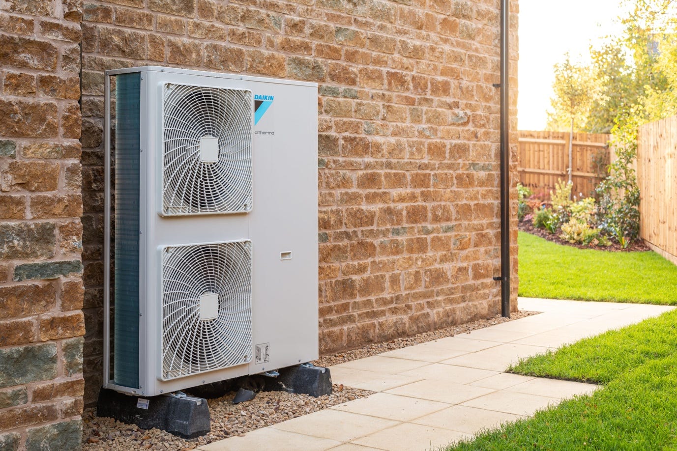 A white air conditioner outside of a brick building

Description automatically generated