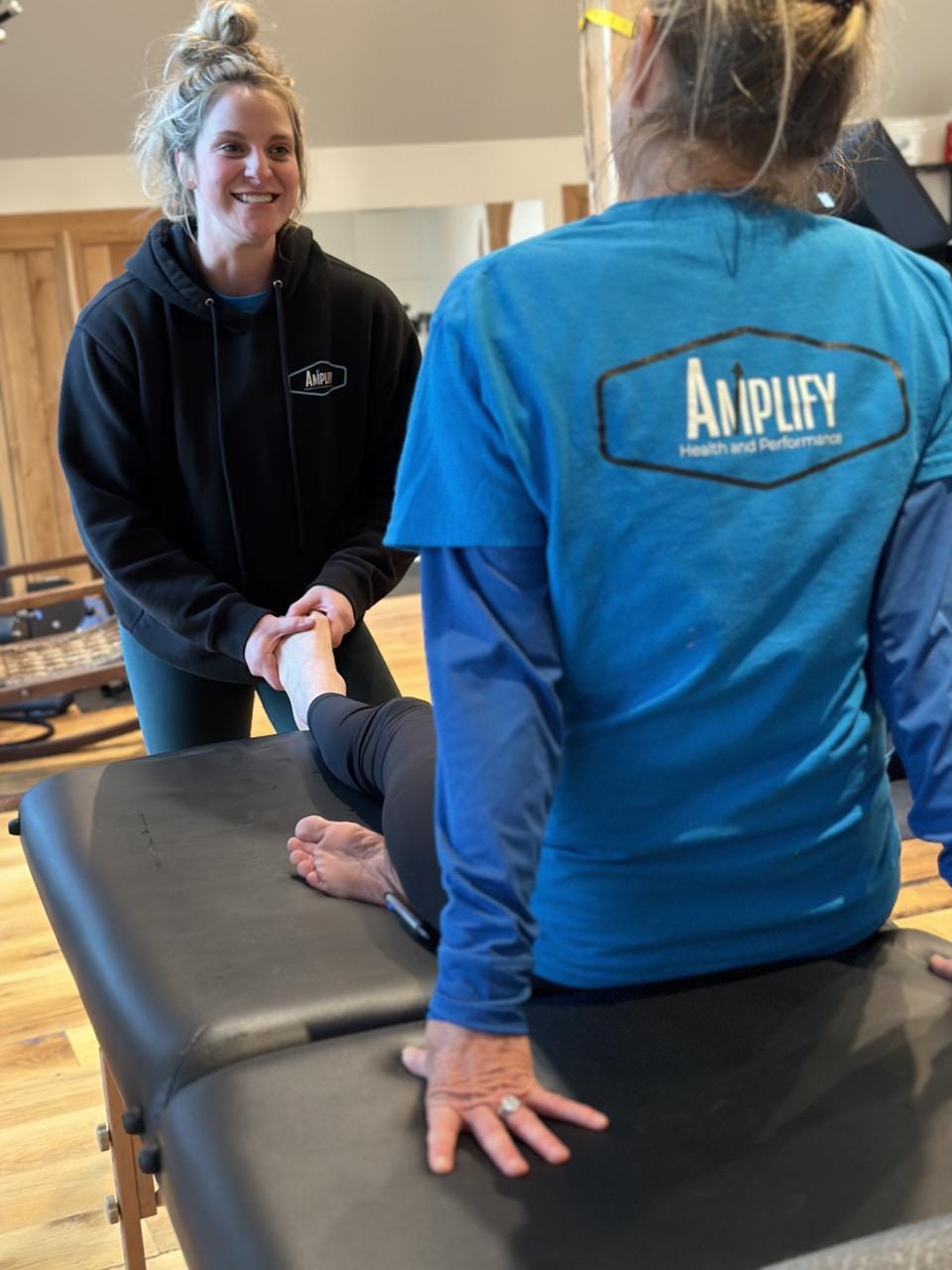 Alex Philips - a premier physical therapist - works with Tracy on stretching exercises.