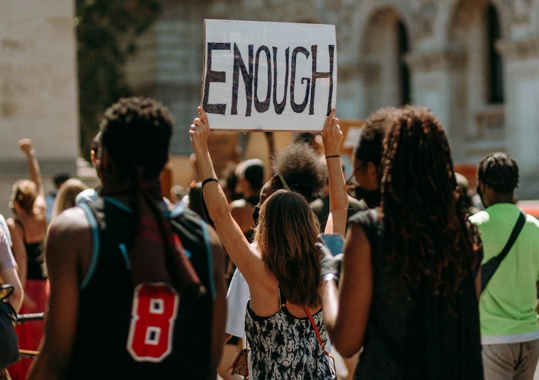 people holding a signage during daytime people holding a signage during daytime
