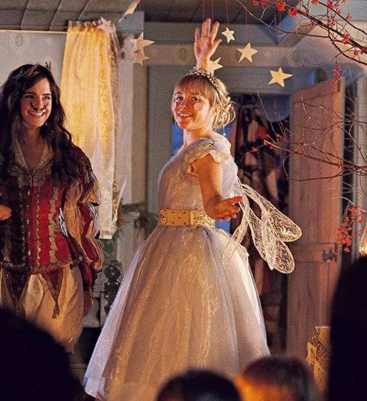 This may contain: two women dressed in costumes standing next to each other