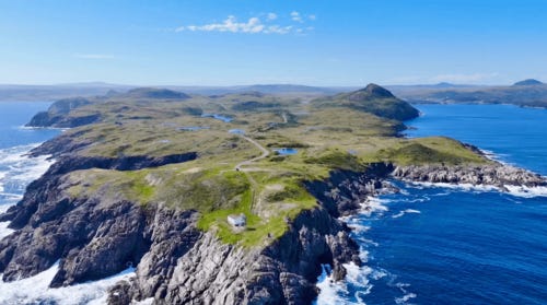 A landscape of a rocky island with a house on top

AI-generated content may be incorrect.