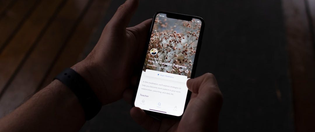 a person holding a cell phone in their hand