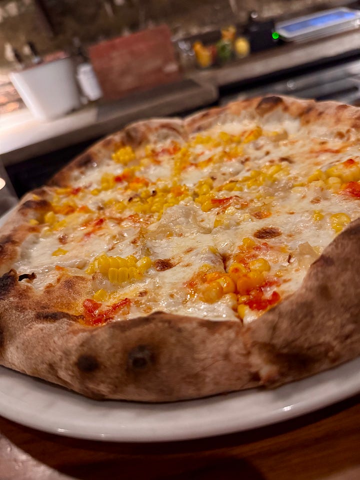tomatoes, a bottle, and a pizza