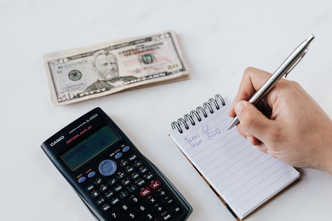 Free Crop anonymous financier planning budget writing numbers in notebook Stock Photo Free Crop anonymous financier planning budget writing numbers in notebook Stock Photo