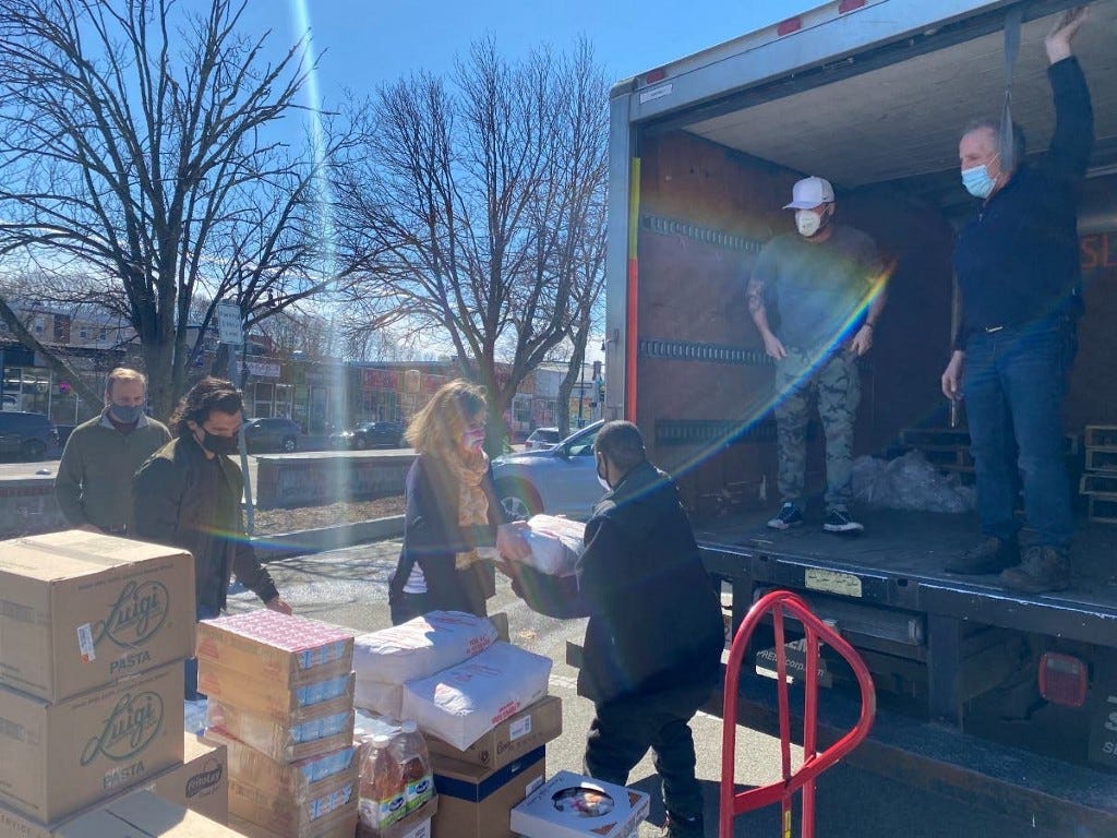 Volunteers load food donations on a truck Volunteers load food donations on a truck