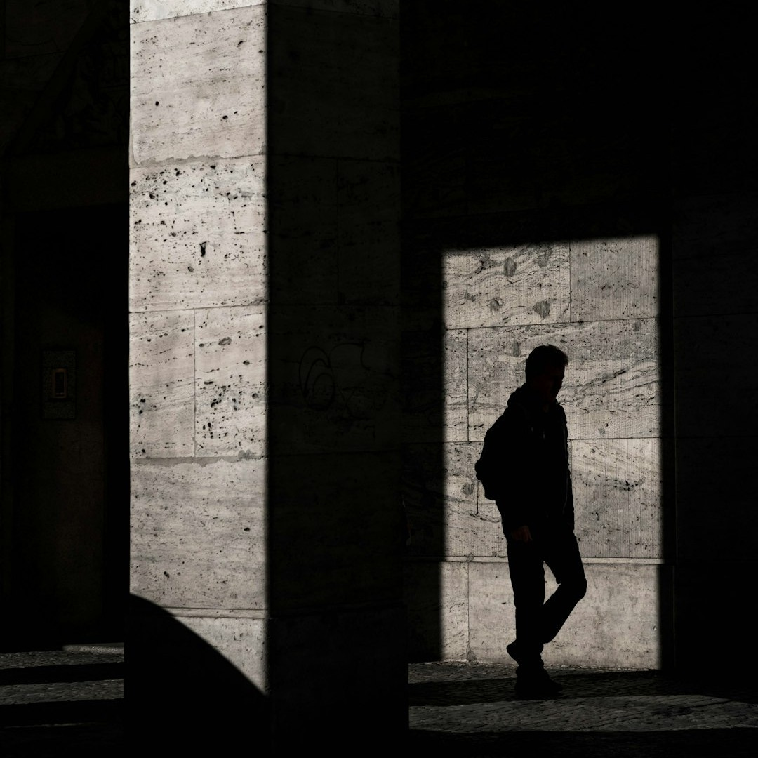 silhouette of man standing inside structure