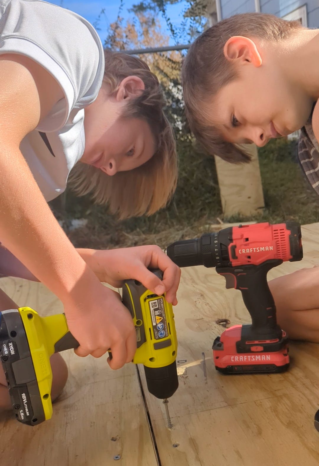 The boys help build a platform for our new shed