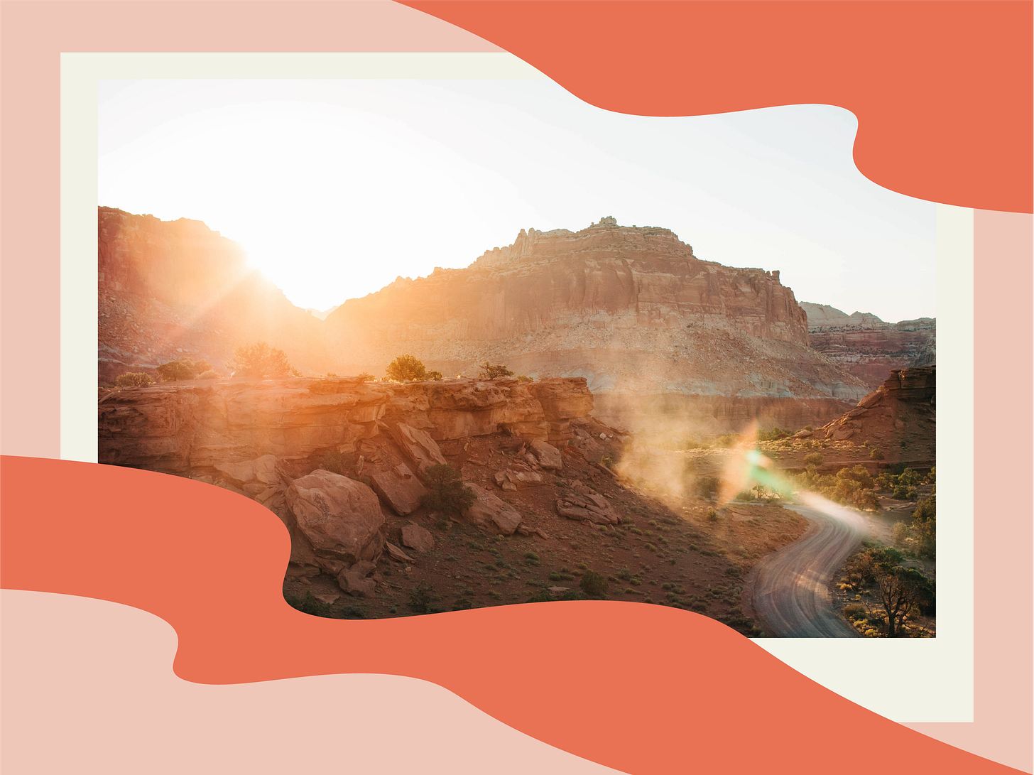 dust rising up from a truck that drove down a desert road during golden hour, with sun shining behind the foothills