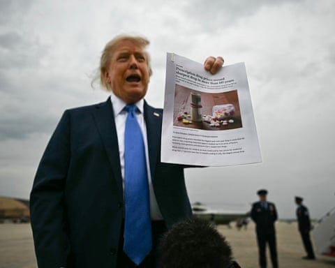 Man in suit on tarmac holds print-out.