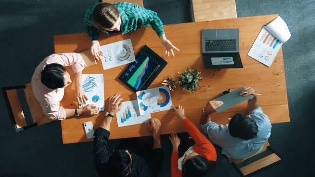 Top down view of smart business woman explain and present chart. Convocation. Top down view of business woman explain and present financial chart. Diverse group discuss and listen presentation about stock market statistic at meeting table with investment graph. Convocation. startup company stock pictures, royalty-free photos & images Top down view of smart business woman explain and present chart. Convocation. Top down view of business woman explain and present financial chart. Diverse group discuss and listen presentation about stock market statistic at meeting table with investment graph. Convocation. startup company stock pictures, royalty-free photos & images