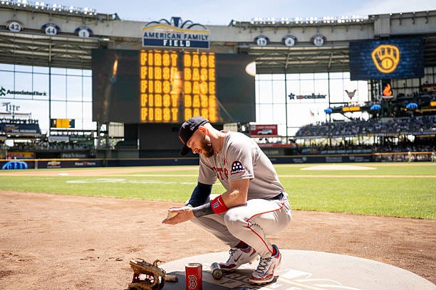 Trevor Story of the Boston Red Sox squats in the on-deck circle before a game against the Milwaukee Brewers at American Family Field on May 26, 2025...