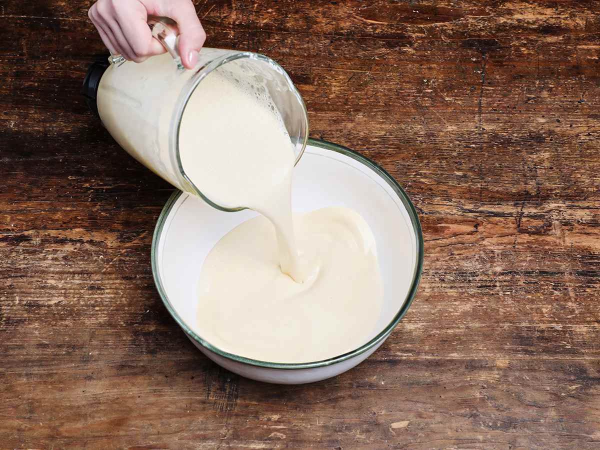 pouring flan mixture into bowl pouring flan mixture into bowl