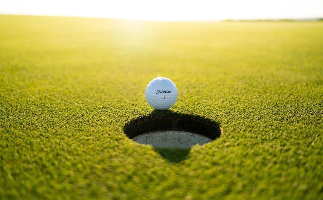 golf ball on green grass field during daytime