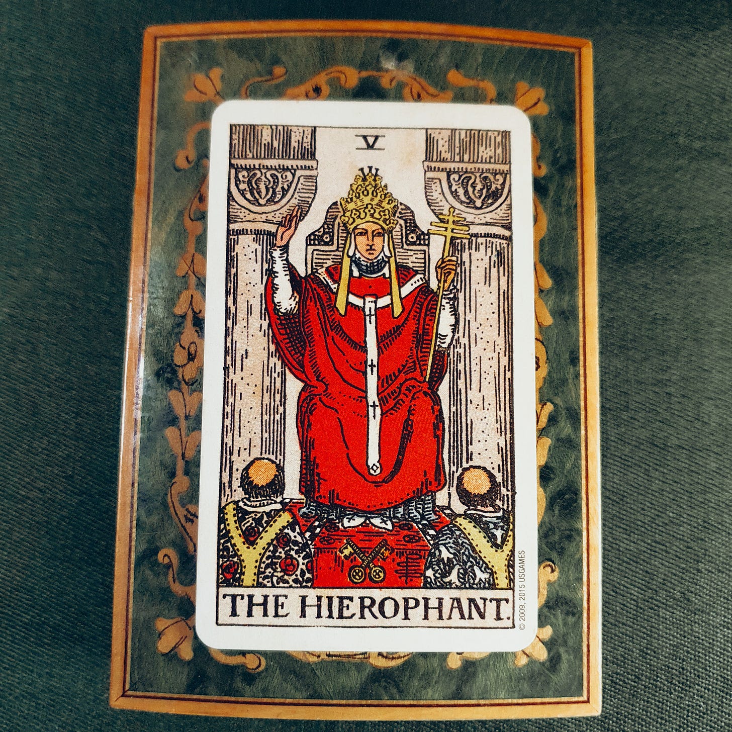 Rider-Waite-Smith Hierophant tarot card used as the Anchor card in Claire Gilman’s Tarot DMs interview, showing the seated Hierophant between two pillars with two figures kneeling below.