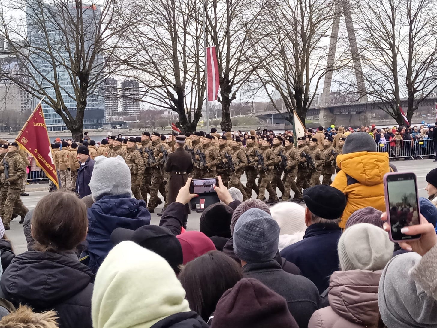 May be an image of 3 people, crowd and text