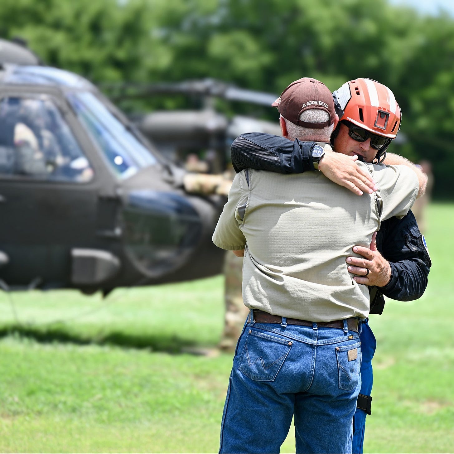 Rescue worker comforts man in Kerr County, Texas, where the search continues for more than 160 people missing following a deadly flood. Rescue worker comforts man in Kerr County, Texas, where the search continues for more than 160 people missing following a deadly flood.