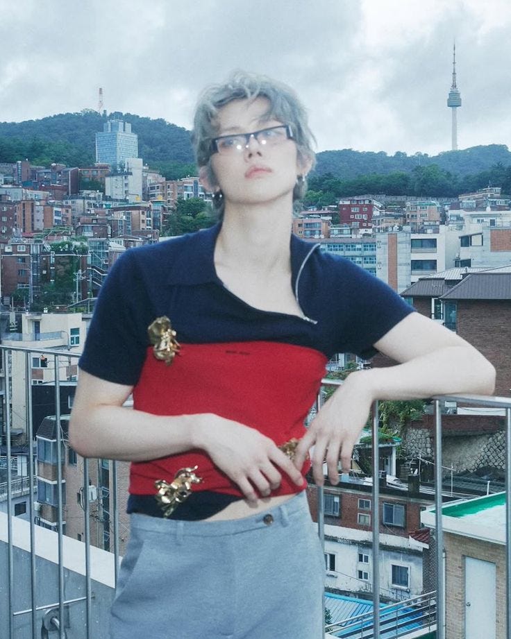 This may contain: a woman standing on top of a roof with her arms crossed This may contain: a woman standing on top of a roof with her arms crossed