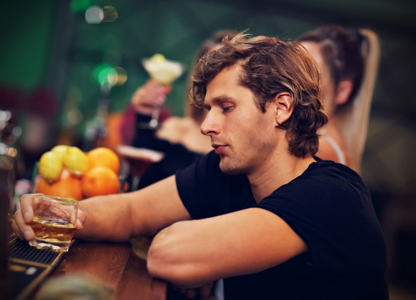 A man sitting alone at a bar. A man sitting alone at a bar.