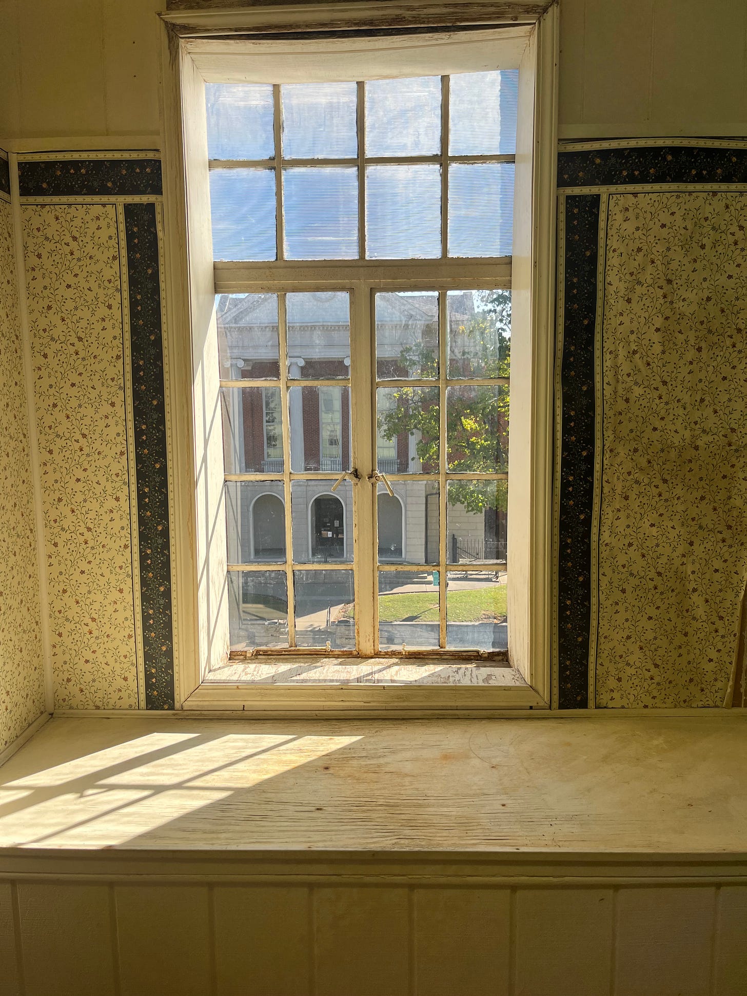 Multi-paned window looking out on the courthouse behind