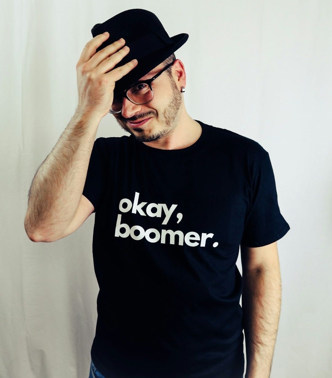 man in black crew neck t-shirt wearing black fedora hat