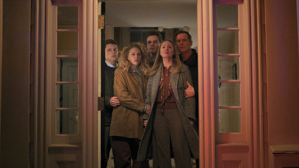 The Hollingsworths grouped together as they stand in a doorway.