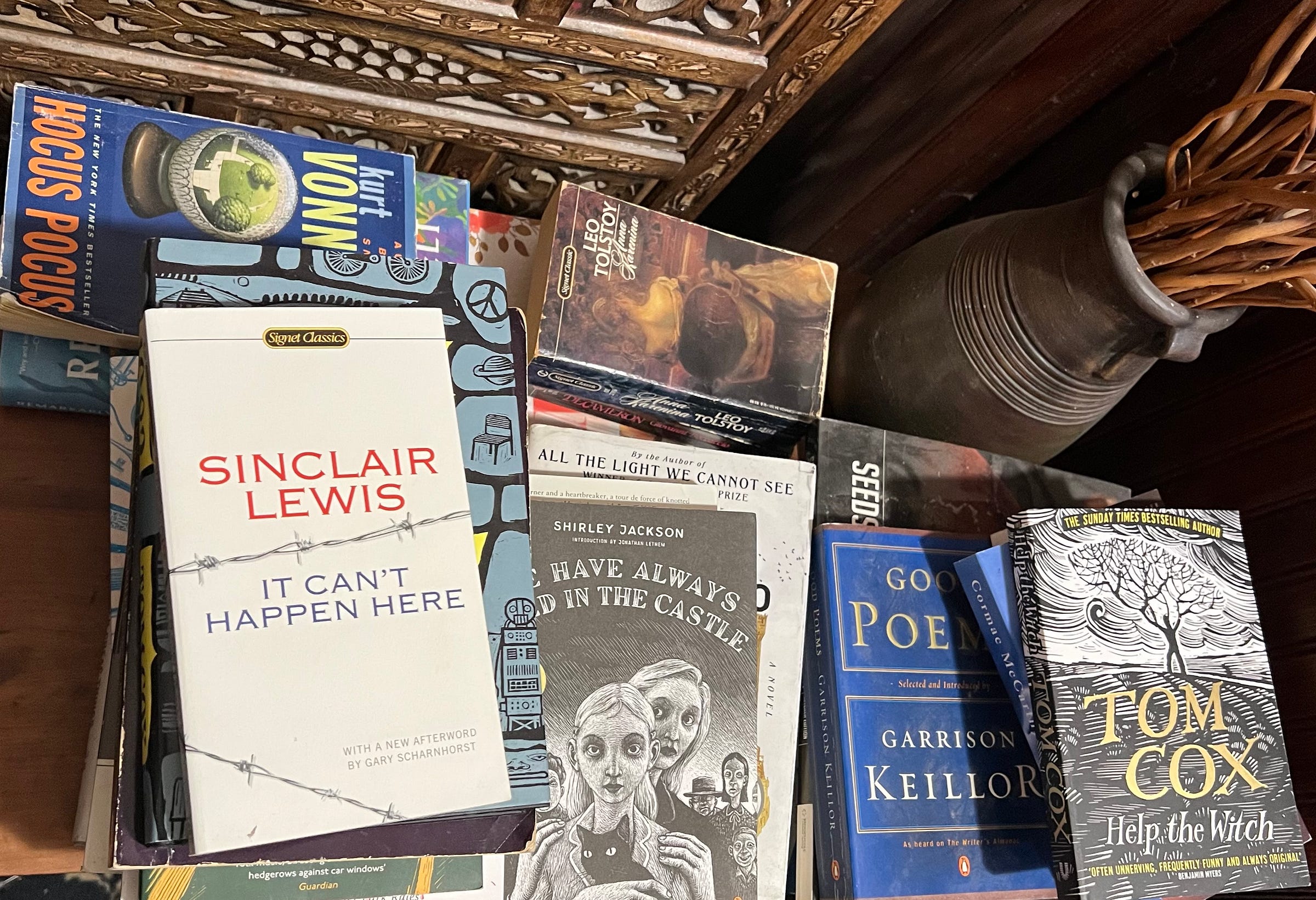 A cluttered table of books A cluttered table of books