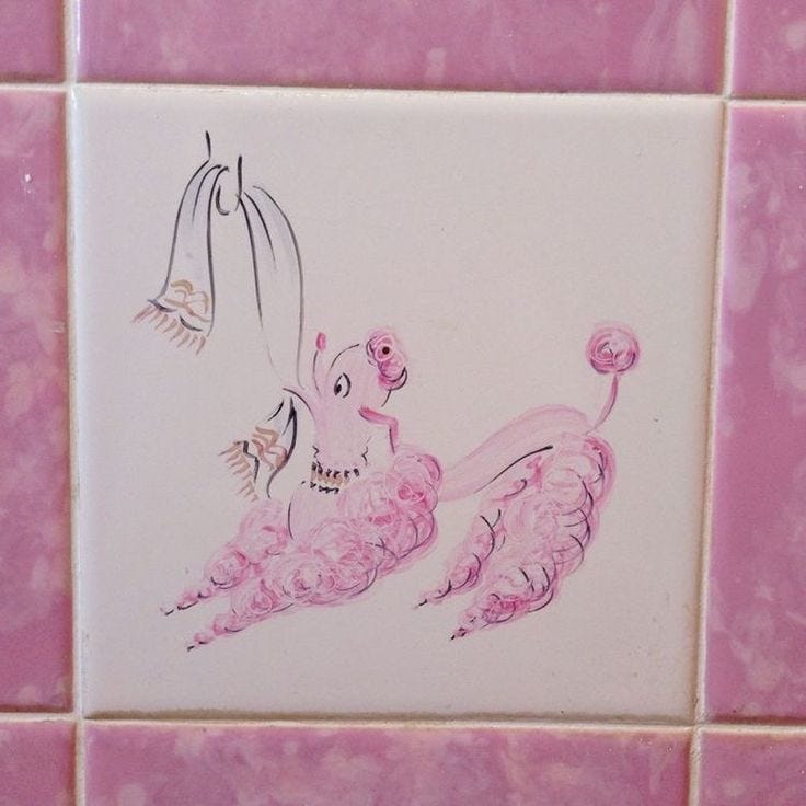This may contain: a pink tiled wall with an artistic painting on it