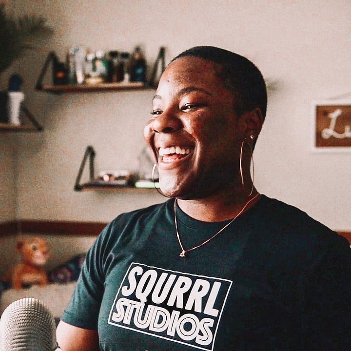 Kahdija Imari poses for a photo during her first podcast and post production business venture "Squrrl Studios." Kahdija Imari's AI twin poses in a home office space.