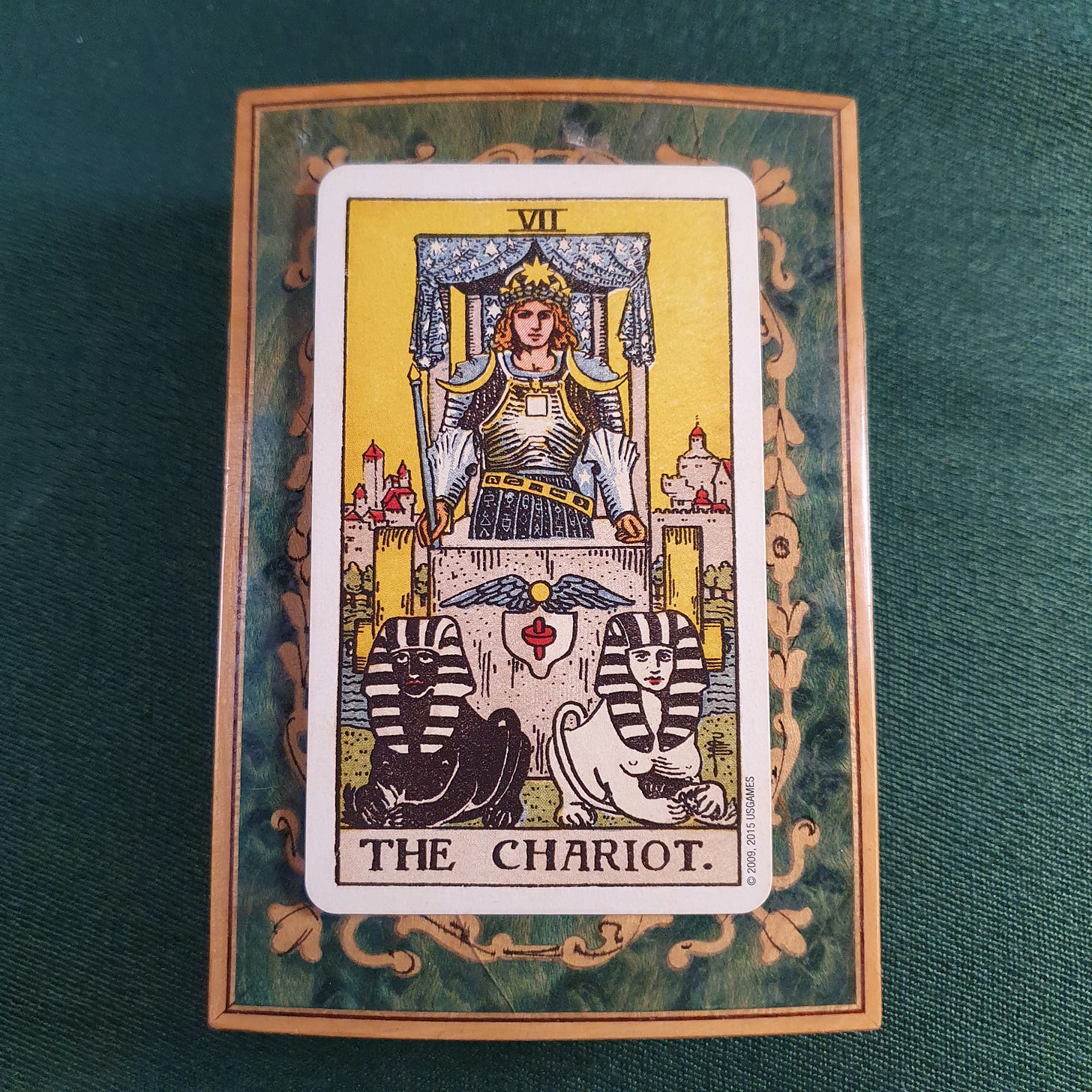 Rider-Waite-Smith Chariot tarot card chosen for Claire Gilman by the previous Tarot DMs guest, showing an armoured charioteer above two black-and-white sphinxes.