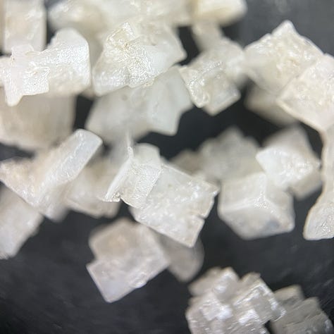 close up images of salt crystals on a black background