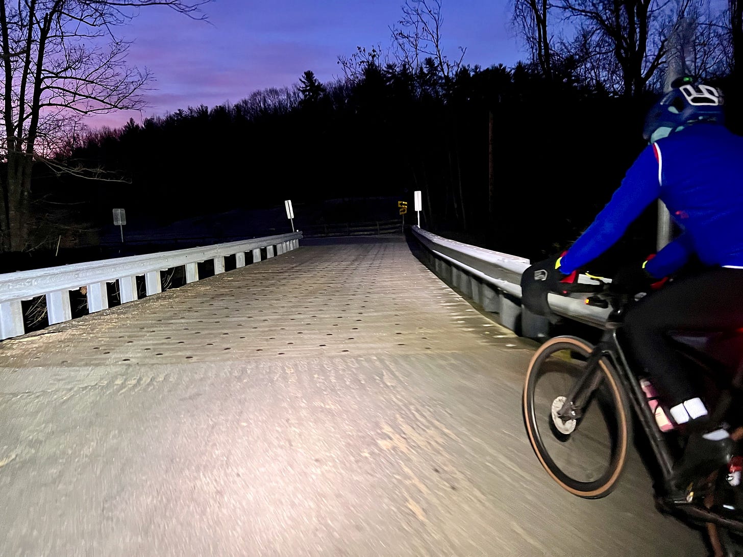 Friend on bicycle crossing a frosty bridge