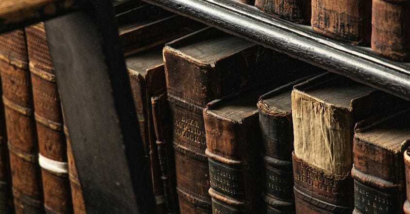 brown wooden book shelf with books brown wooden book shelf with books