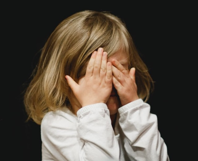 girl covering her face with both hands girl covering her face with both hands