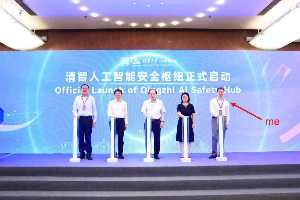 Five people on stage at Qingzhi AI Safety Hub launch, arrow labeled