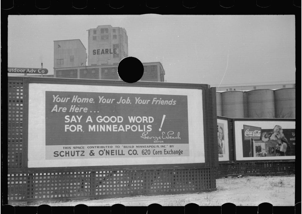Black and white photo of billboard in front of grain elevators. The billboard reads: "Your home, your job, your friends are here... Say a Good Word For Minneapolis!" Black and white photo of billboard in front of grain elevators. The billboard reads: "Your home, your job, your friends are here... Say a Good Word For Minneapolis!"