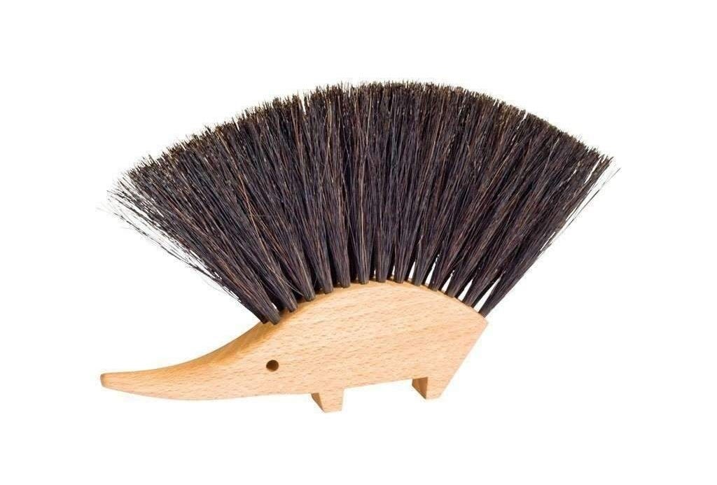 Wooden brush shaped like a hedgehog with long brown bristles