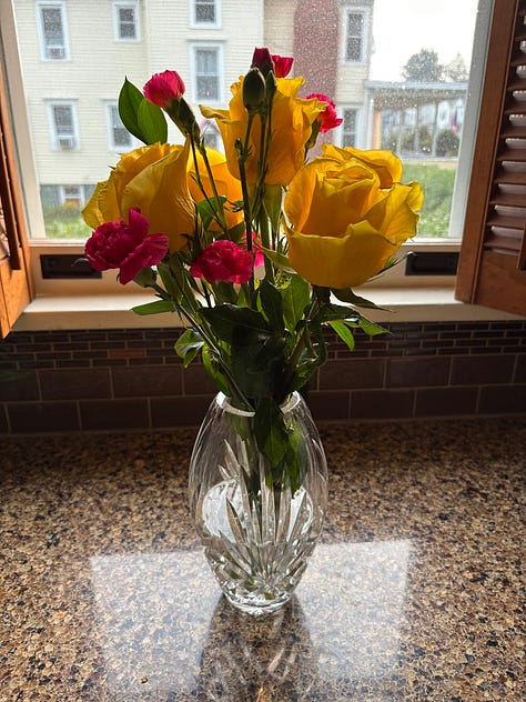 A vase or yellow, pink and red roses.. A vase of pink. A vase of assorted white flowers.
