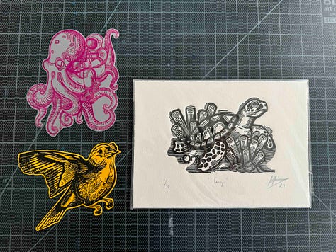Linoleum prints, a clay print, stickers, and a hand stitched bag