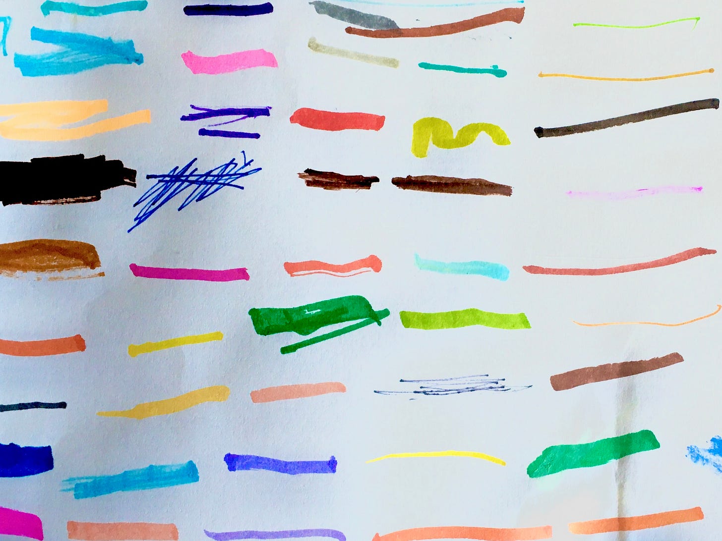 several color strips drawn by a child to display the variety of color options in her marker drawer.