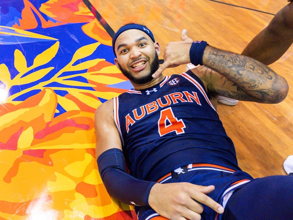 Johni Broome celebrates after falling to the floor as Auburn defeats Iowa State on NOv. 25, 2024. 