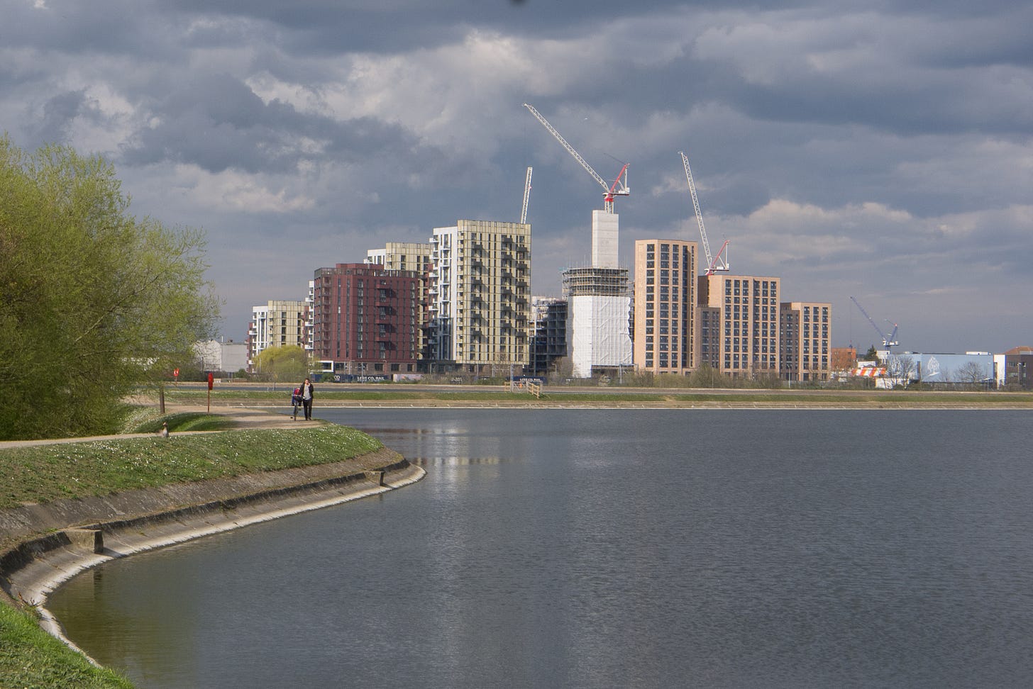 tower blocks and cranes above reservoir
