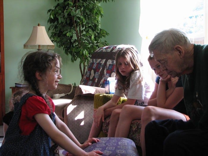 Grandpa interacting with his granddaughters